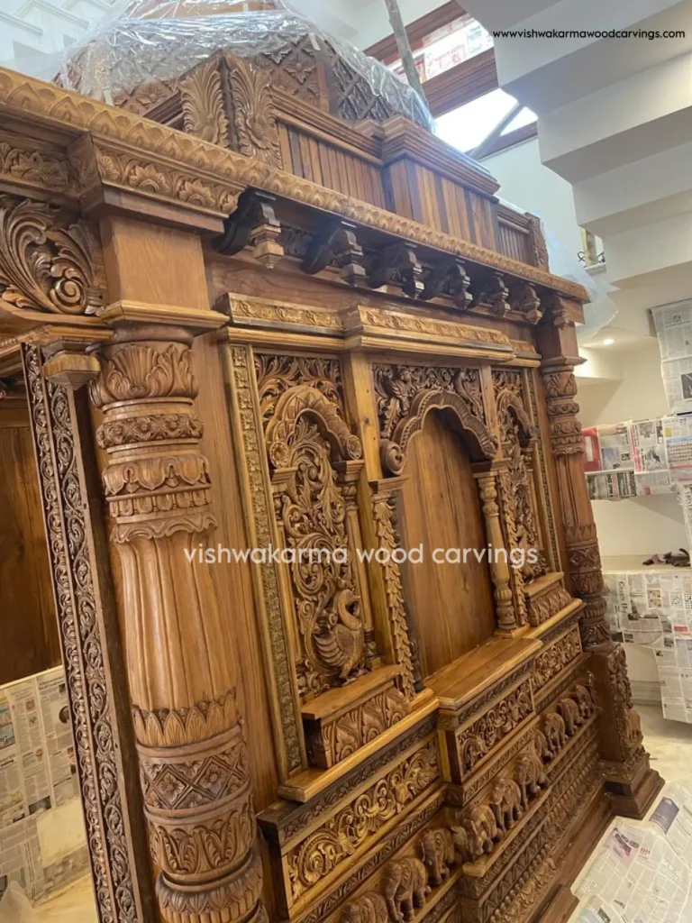 Belur style hand-carved wooden pooja room with traditional Hoysala pillars by Vishwakarma Wood Carvings
