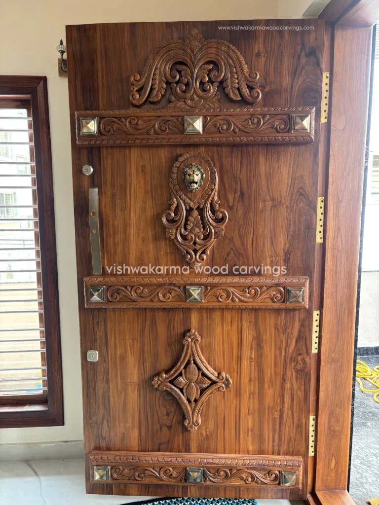 Hand-carved wooden main door with traditional carving design by Vishwakarma Wood Carvings