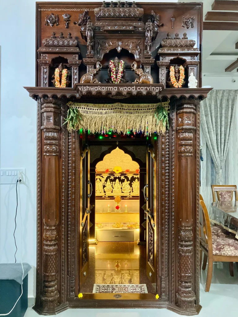 Hoysala-style teakwood pooja room with intricate carvings by Vishwakarma Wood Carvings