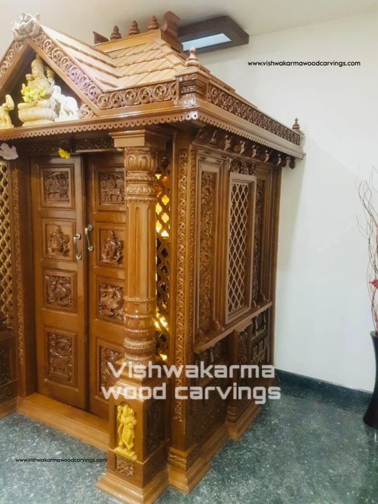 South Indian style pooja room wooden carvings with pillars and ornamental detailing by Vishwakarma Wood Carvings