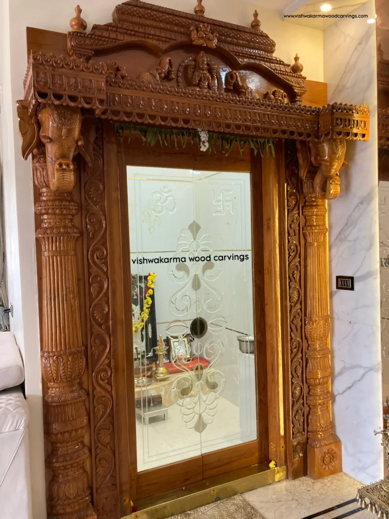 Hand-carved Gajalakshmi wooden design featuring Goddess Lakshmi with elephant heads in traditional temple style.