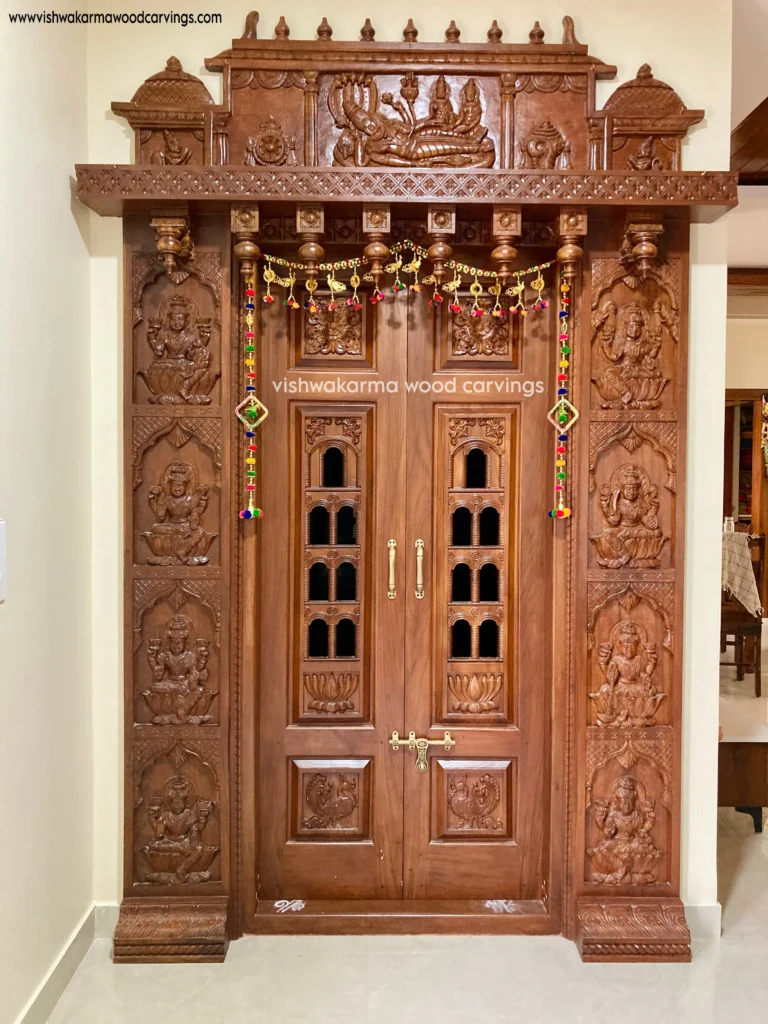 Hand-carved wooden temple door with Ashta Lakshmi carvings and Lord Vishnu panel